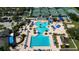 Aerial view of a large community pool with a kiddie pool area, lounge chairs, and mature landscaping at 19309 Seacove Dr, Lutz, FL 33558