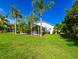 Lush backyard featuring a screened lanai and vibrant green lawn, perfect for outdoor activities and relaxation in a private setting at 19309 Seacove Dr, Lutz, FL 33558