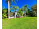 Expansive backyard with well-maintained lawn, offering plenty of room for outdoor activities and enjoying the natural surroundings at 19309 Seacove Dr, Lutz, FL 33558