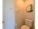 Powder room with light walls, tile flooring, and a decorative lighthouse-themed mirror at 19309 Seacove Dr, Lutz, FL 33558