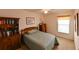 Bedroom with a ceiling fan, a dresser, a picture on the wall, and a nice-sized window at 19309 Seacove Dr, Lutz, FL 33558