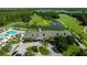 Aerial view of the community clubhouse, swimming pool, parking lot, and surrounding golf course at 19309 Seacove Dr, Lutz, FL 33558