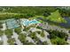 Aerial view of community amenities featuring tennis courts, playground, clubhouse, and swimming pool at 19309 Seacove Dr, Lutz, FL 33558