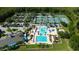 Aerial view showcasing a swimming pool, tennis courts, basketball court, and community playground at 19309 Seacove Dr, Lutz, FL 33558