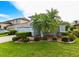 Lovely home with a two-car garage, front garden, and lush green lawn in a serene neighborhood at 19309 Seacove Dr, Lutz, FL 33558