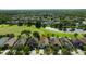 Aerial view of home in a golf course community with mature trees and lush landscaping at 19309 Seacove Dr, Lutz, FL 33558