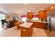 Open kitchen with an island and an eat-in dining table open to a living area with a leather couch at 19309 Seacove Dr, Lutz, FL 33558