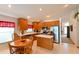Bright kitchen with stainless steel appliances, wooden cabinets, tile floor and adjacent breakfast nook with table at 19309 Seacove Dr, Lutz, FL 33558