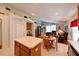 Open-concept kitchen with white countertops, center island, wooden cabinets, and adjacent living area at 19309 Seacove Dr, Lutz, FL 33558