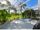 Outdoor screened-in patio with pool and lush landscaping, providing a serene and private oasis for relaxation and enjoyment at 19309 Seacove Dr, Lutz, FL 33558