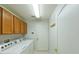 Bright laundry room with modern washer and dryer, storage cabinets and easy access to the outside at 19309 Seacove Dr, Lutz, FL 33558