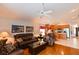 Comfortable living room with leather seating, hardwood floors, and a view into the adjacent kitchen area at 19309 Seacove Dr, Lutz, FL 33558