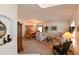 Open-concept living and dining area with carpet flooring, chandelier, and neutral paint at 19309 Seacove Dr, Lutz, FL 33558