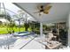 Screened-in patio with a ceiling fan, a hot tub, and some nice outdoor seating at 19309 Seacove Dr, Lutz, FL 33558