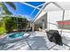 Large, screened-in patio, a hot tub, ceiling fan, and views of the surrounding yard at 19309 Seacove Dr, Lutz, FL 33558