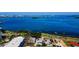 Breathtaking aerial view of waterfront homes, showcasing stunning ocean views and lush tropical landscaping at 1951 Edgewater Dr, Clearwater, FL 33755