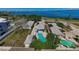 Stunning aerial view showcasing the home's layout, sparkling pool, and proximity to the water at 1951 Edgewater Dr, Clearwater, FL 33755