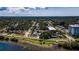 Scenic aerial perspective of waterfront homes and condos nestled among lush trees beneath a beautiful sky at 1951 Edgewater Dr, Clearwater, FL 33755