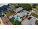 A beautiful waterfront property with a pool and solar panels; also features a detached guest house at 1951 Edgewater Dr, Clearwater, FL 33755
