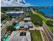 This waterfront home features a pool, separate guest house, and easy access to the city at 1951 Edgewater Dr, Clearwater, FL 33755