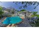 Inviting backyard featuring a sparkling pool, comfortable seating, and a charming home exterior at 1951 Edgewater Dr, Clearwater, FL 33755