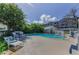 Secluded backyard featuring a pristine pool, a shed, and mature landscaping for privacy and enjoyment at 1951 Edgewater Dr, Clearwater, FL 33755