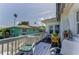 Relaxing outdoor balcony with comfortable seating and views of nearby homes and palm trees at 1951 Edgewater Dr, Clearwater, FL 33755