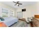 Bedroom features a ceiling fan, hardwood floors, a window, and vintage furniture at 1951 Edgewater Dr, Clearwater, FL 33755