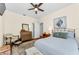 Bright bedroom features hardwood floors, ceiling fan, wall art, and traditional furnishings at 1951 Edgewater Dr, Clearwater, FL 33755