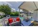 Inviting outdoor deck with comfortable seating and a view of the sparkling pool and lush backyard at 1951 Edgewater Dr, Clearwater, FL 33755
