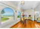Bright dining area with hardwood floors and beautiful water view from the arched windows at 1951 Edgewater Dr, Clearwater, FL 33755