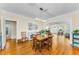 Dining room featuring hardwood floors, modern chandelier and open concept layout at 1951 Edgewater Dr, Clearwater, FL 33755