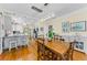 Dining room features wooden table set, hardwood floors, and access to the kitchen at 1951 Edgewater Dr, Clearwater, FL 33755