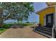 Home near water featuring brick driveway, steps to the front door, and a view of the bay at 1951 Edgewater Dr, Clearwater, FL 33755