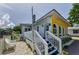 Bright home with a charming deck, complemented by a beautifully landscaped yard and inviting entrance at 1951 Edgewater Dr, Clearwater, FL 33755
