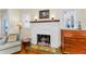 Close-up of a fireplace featuring a vintage mantle with decorative tiles and wall sconces at 1951 Edgewater Dr, Clearwater, FL 33755
