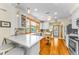 Bright kitchen with white cabinets, hardwood floors, stainless appliances, and center island at 1951 Edgewater Dr, Clearwater, FL 33755