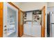 Efficient laundry area featuring a white washer and dryer, storage shelves, and bright natural light at 1951 Edgewater Dr, Clearwater, FL 33755