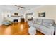 Charming living room featuring a fireplace, stained-glass windows and hardwood flooring at 1951 Edgewater Dr, Clearwater, FL 33755