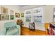 Cozy living area with a comfortable chair, vintage sewing machine, and sun-filled windows at 1951 Edgewater Dr, Clearwater, FL 33755