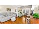 Comfortable living room with hardwood floors, a plush sofa, and a relaxing chair at 1951 Edgewater Dr, Clearwater, FL 33755