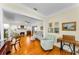 Bright living room featuring a fireplace, hardwood floors, and an open floor plan at 1951 Edgewater Dr, Clearwater, FL 33755