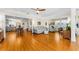 Spacious living room featuring hardwood floors, a ceiling fan, and an open floor plan at 1951 Edgewater Dr, Clearwater, FL 33755
