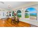 Bright dining area with stunning water views through arched windows, enhancing the home's appeal at 1951 Edgewater Dr, Clearwater, FL 33755