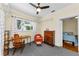 Cozy office area features gray carpeting, desk with chair, and an adjacent bedroom at 1951 Edgewater Dr, Clearwater, FL 33755
