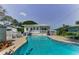 A gorgeous kidney-shaped pool and deck provide the perfect backyard oasis to entertain or relax at 1951 Edgewater Dr, Clearwater, FL 33755