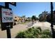 Street view featuring a Jolly Trolley stop, charming storefronts, palm trees, and pedestrian walkways at 1951 Edgewater Dr, Clearwater, FL 33755