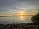 Scenic waterfront view with a tranquil body of water and golden sun reflecting off the water's surface at 1951 Edgewater Dr, Clearwater, FL 33755