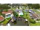 Stunning aerial view showcasing a waterfront home with a pool, boat dock, and lush landscaping in a desirable neighborhood at 1964 Tanglewood Ne Dr, St Petersburg, FL 33702