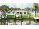 Back exterior of home features outdoor pool, covered patio, lush landscaping, and canal views at 1964 Tanglewood Ne Dr, St Petersburg, FL 33702